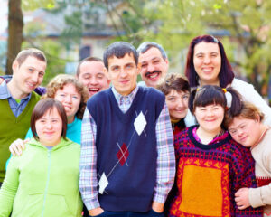 Group of happy NDIS participants smiling together, highlighting eTrack’s ability to help more people