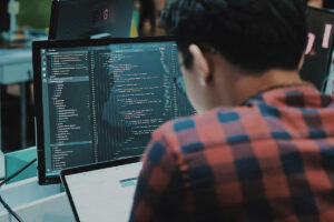 Software developer using etrack crm on screen