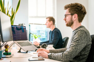 Professionals using etrack CRM on laptop